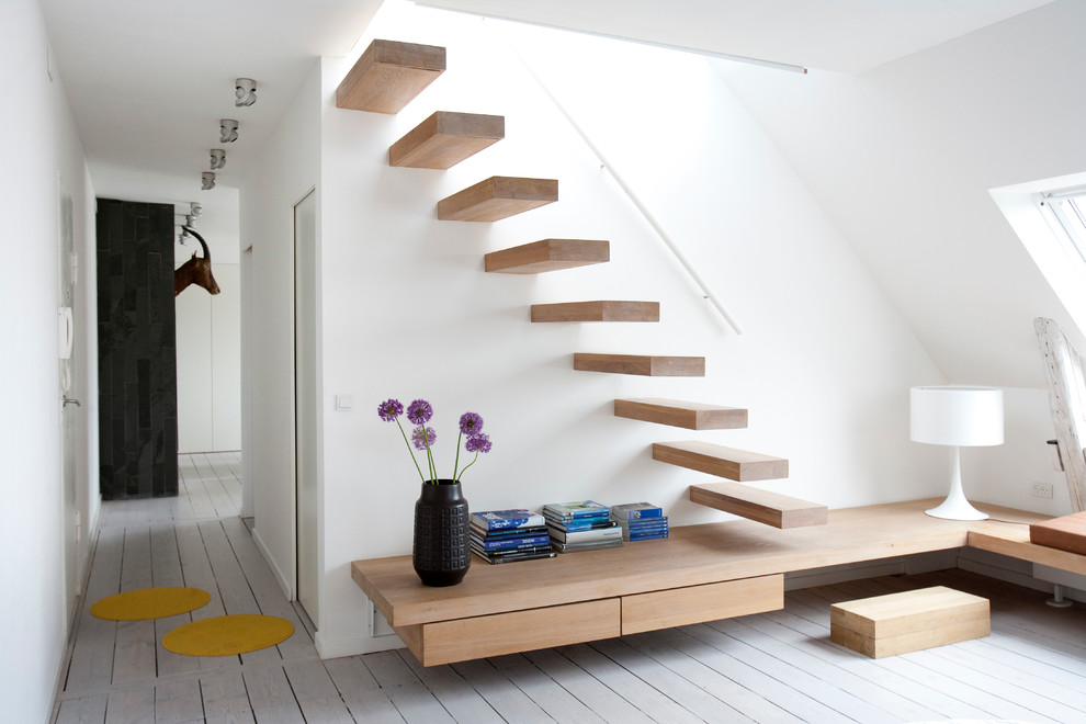 Photo of a modern staircase in Other with feature lighting.