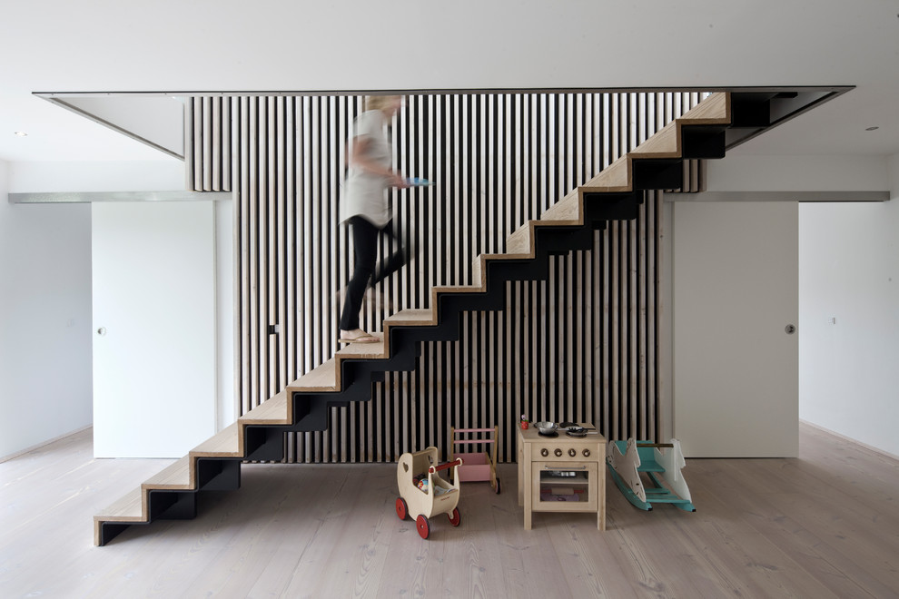 Example of a trendy wooden straight staircase design in Aarhus with wooden risers