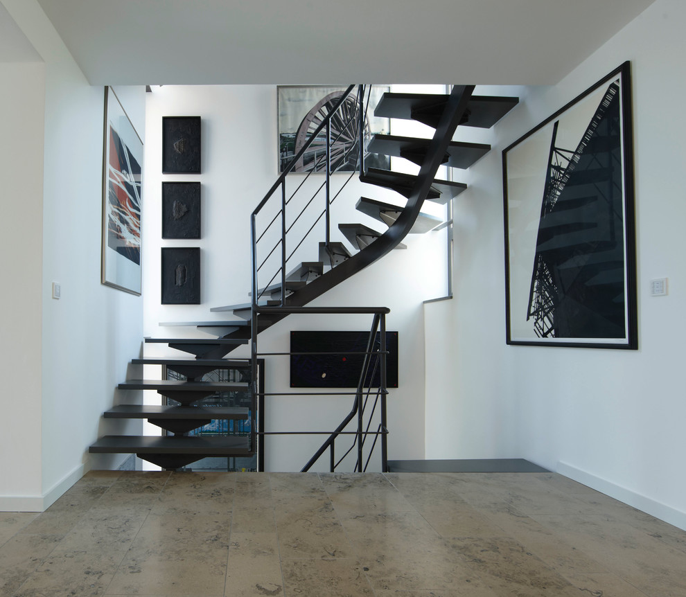 Design ideas for a medium sized contemporary curved staircase in Dortmund with feature lighting.
