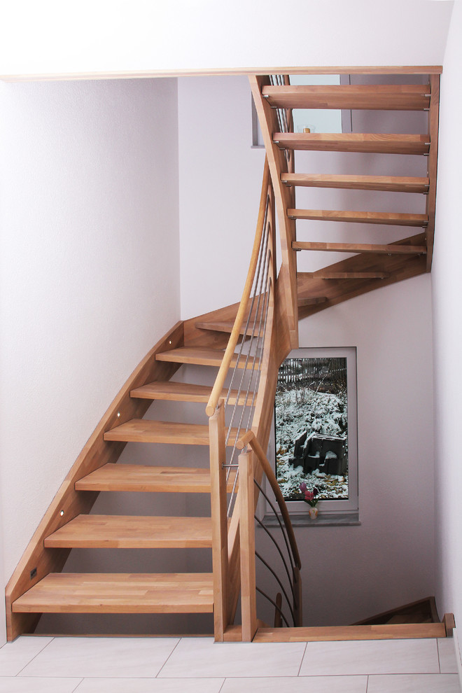 Design ideas for a medium sized country wood curved wood railing staircase in Other.