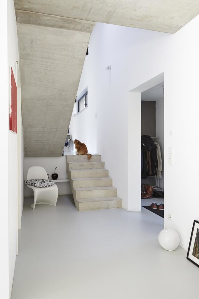 Inspiration pour un escalier minimaliste en U et béton de taille moyenne avec des contremarches en béton.
