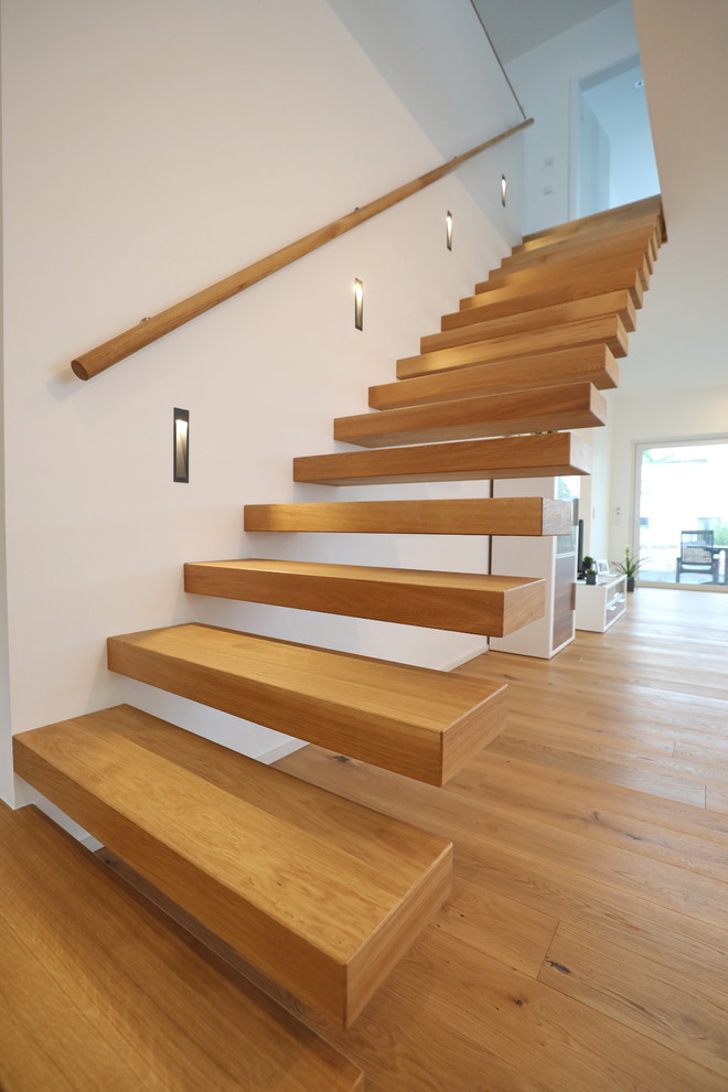 Medium sized scandinavian painted wood straight staircase in Other with open risers.