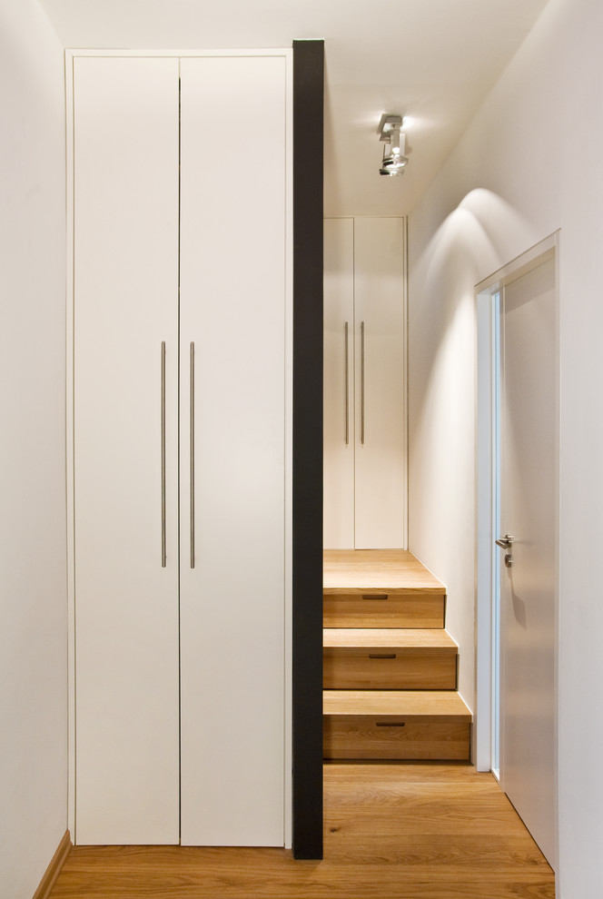 Inspiration for a small contemporary wooden curved staircase remodel in Munich with wooden risers