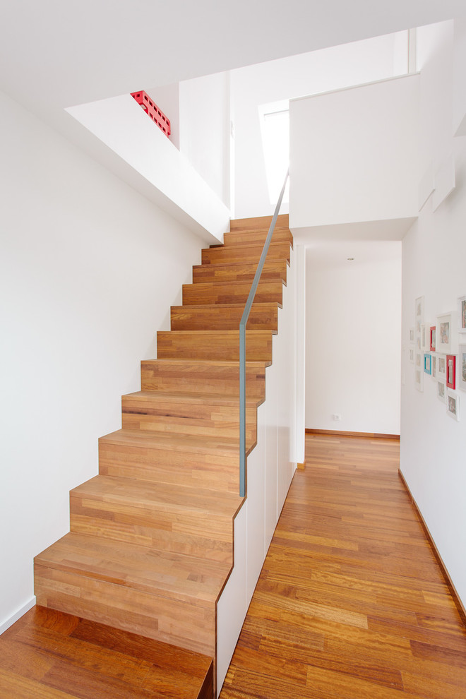 Imagen de escalera recta escandinava pequeña con escalones de madera pintada, contrahuellas de madera pintada y barandilla de metal