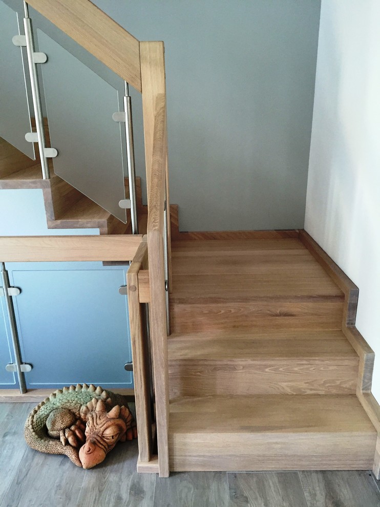 Design ideas for a large contemporary wood curved staircase in Other with wood risers.