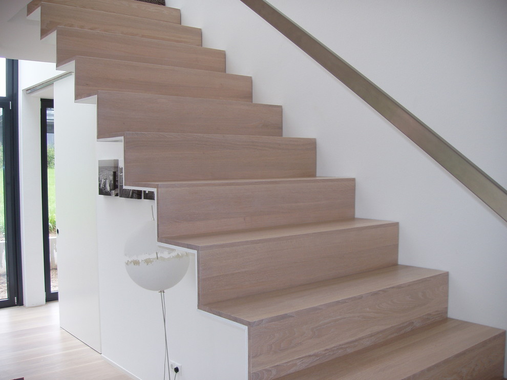 Пример оригинального дизайна: большая прямая лестница в стиле модернизм с крашенными деревянными ступенями, крашенными деревянными подступенками и металлическими перилами