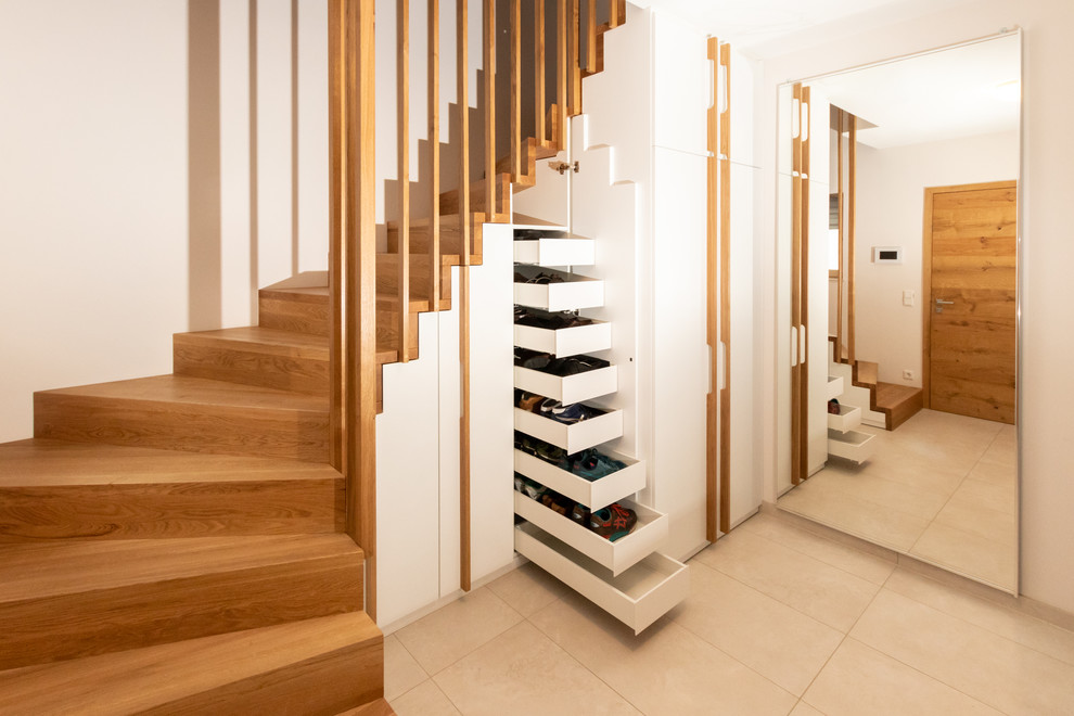 Modern wood curved wood railing staircase in Stuttgart with wood risers.