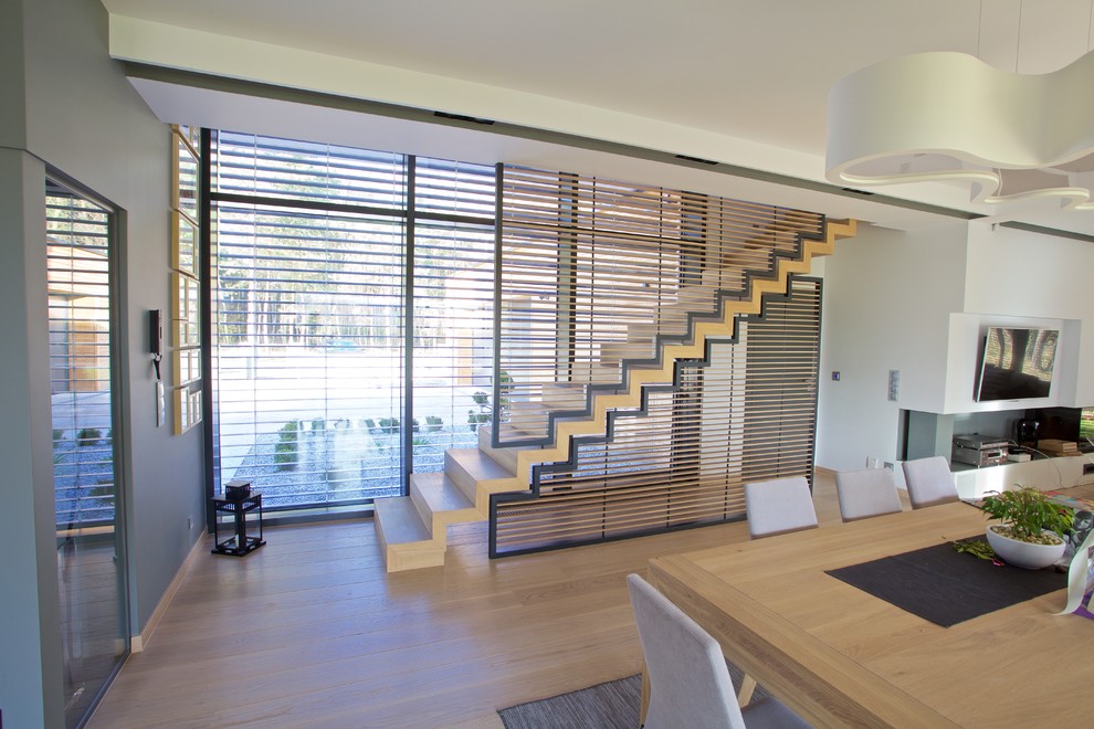 Photo of a large contemporary wood straight staircase in Other with wood risers.