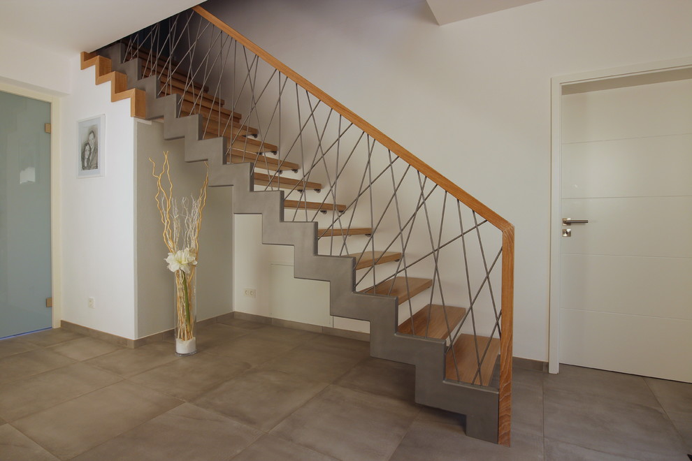 Inspiration for a mid-sized contemporary wooden straight mixed material railing and open staircase remodel in Dresden