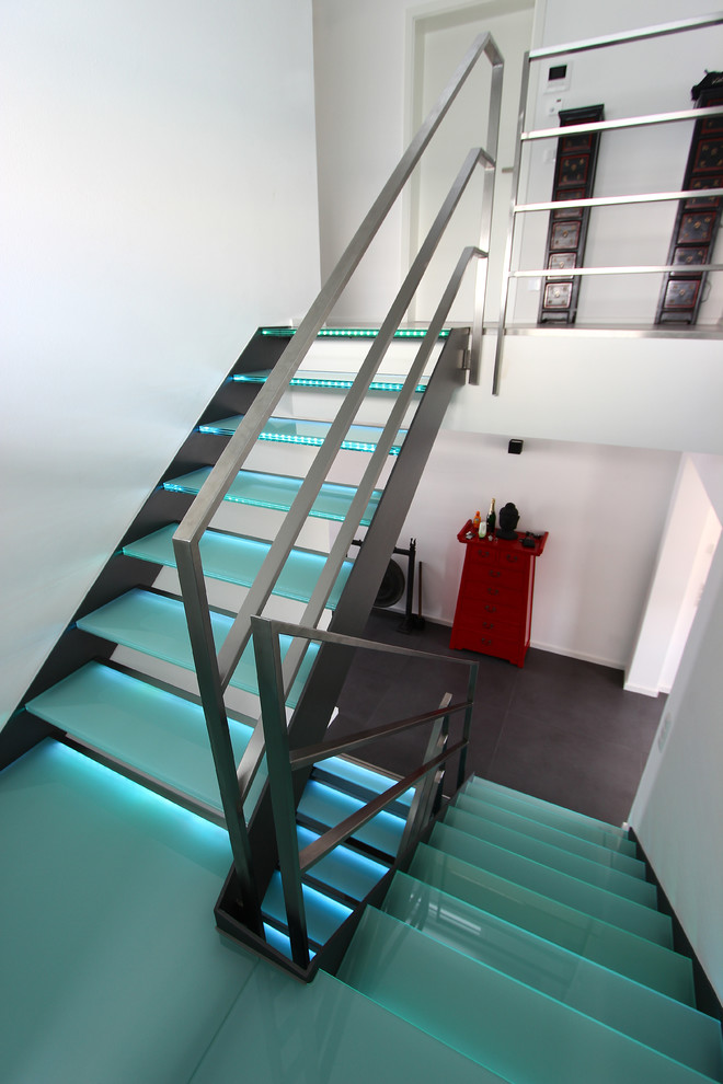 Design ideas for a large contemporary glass spiral staircase in Other with open risers.