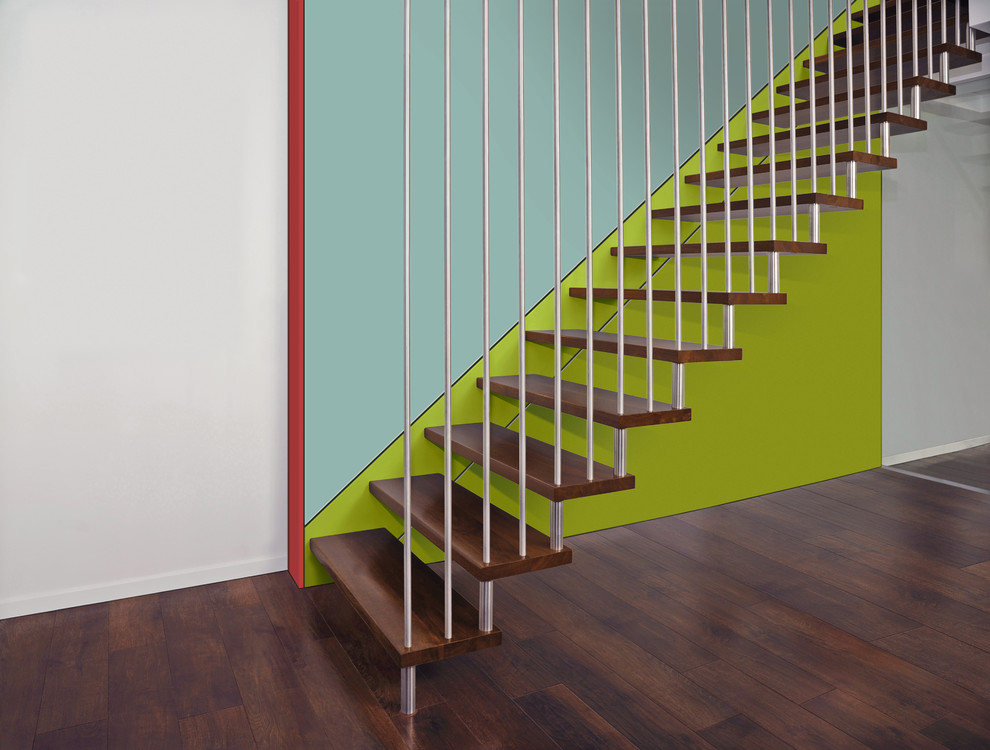 Photo of a large modern wood straight metal railing staircase in Dresden with open risers.