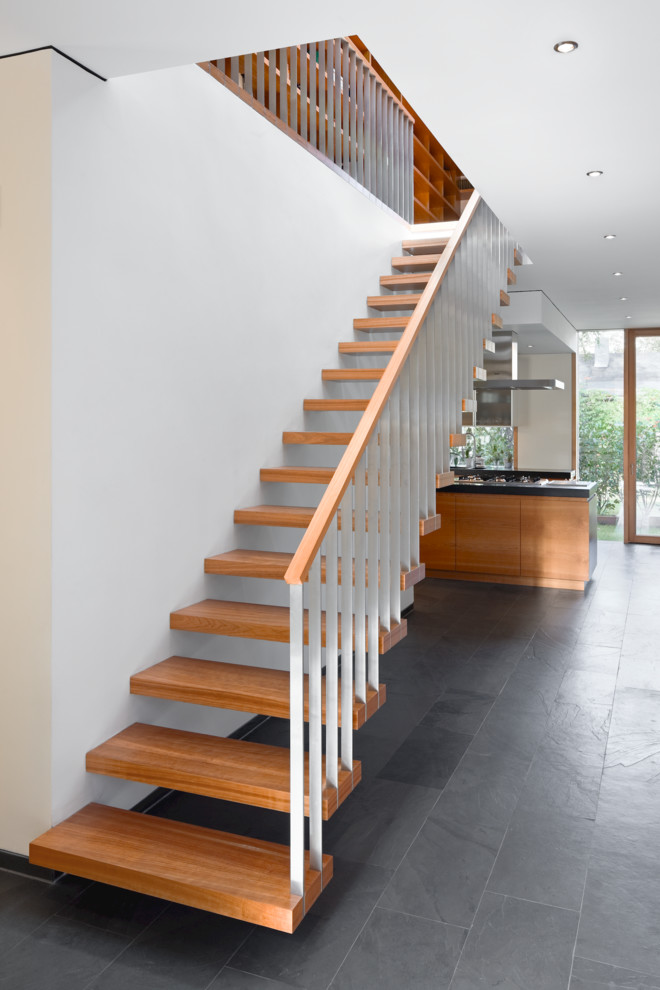 Inspiration for a mid-sized contemporary wooden straight open staircase remodel in Berlin