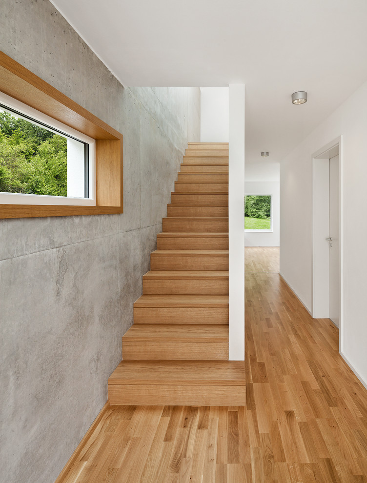 Inspiration for a mid-sized modern wooden straight staircase remodel in Munich with wooden risers