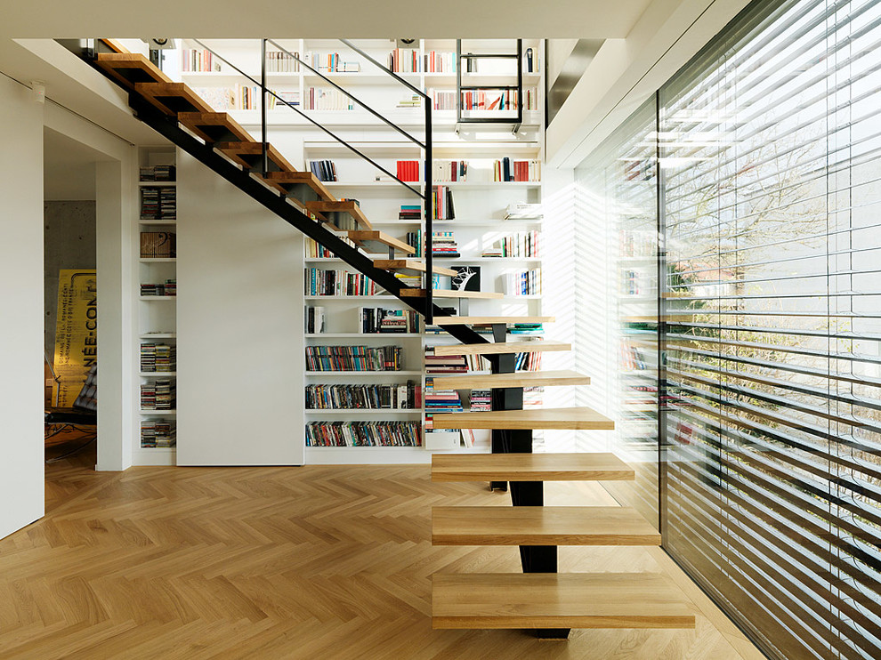 Trendy wooden l-shaped open staircase photo in Other