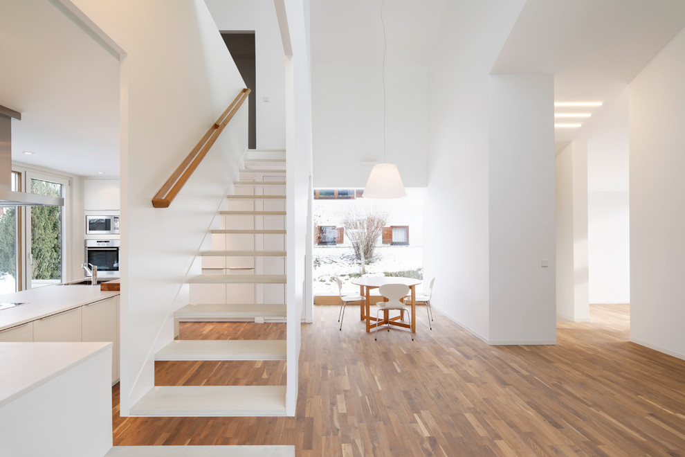Inspiration for an expansive contemporary straight staircase in Cologne with open risers.