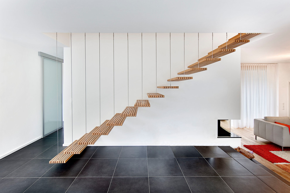Staircase - mid-sized contemporary wooden floating open staircase idea in Stuttgart