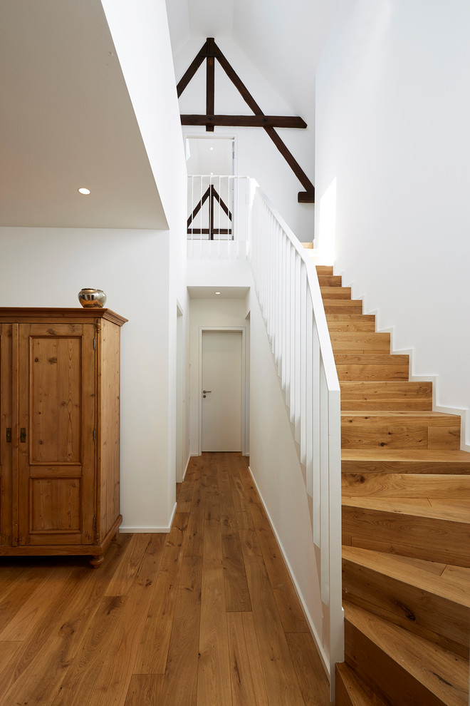 Inspiration pour un grand escalier droit rustique avec un garde-corps en métal, des marches en bois et des contremarches en bois.