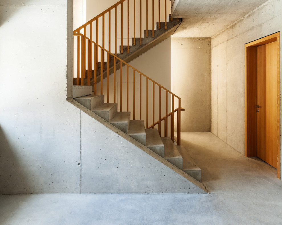 Inspiration for a large contemporary concrete u-shaped staircase remodel in Stuttgart with concrete risers