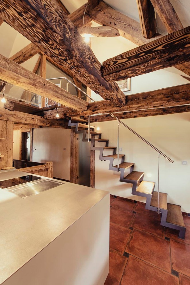 Inspiration for a small rustic wood straight staircase in Other with open risers.