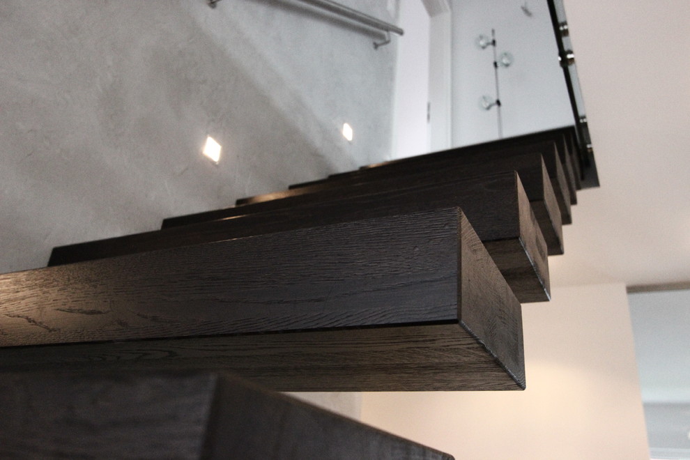 This is an example of a contemporary wood floating staircase in Other with wood risers.