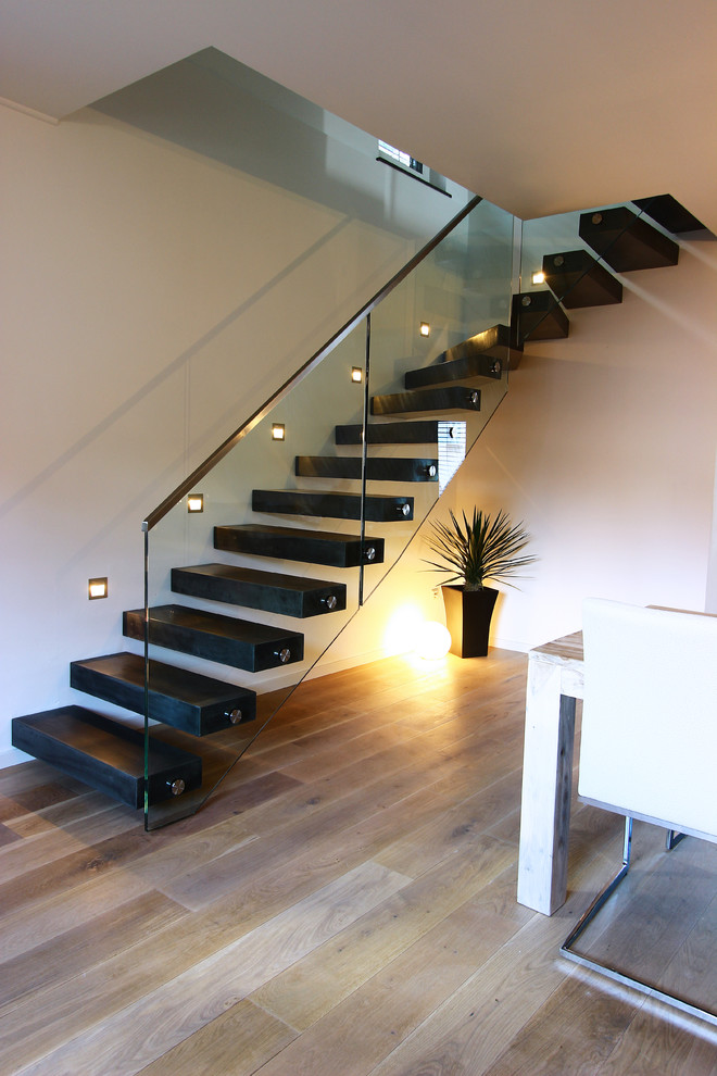 Large minimalist wooden floating staircase photo in Other with wooden risers