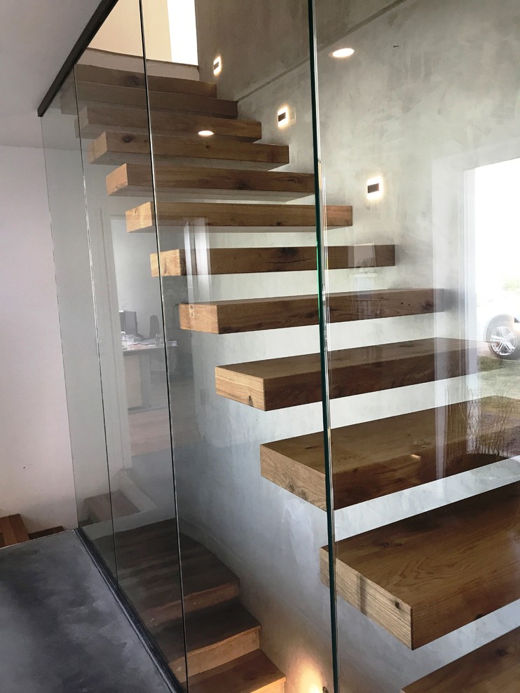 Staircase - large contemporary wooden floating glass railing staircase idea in Other with wooden risers
