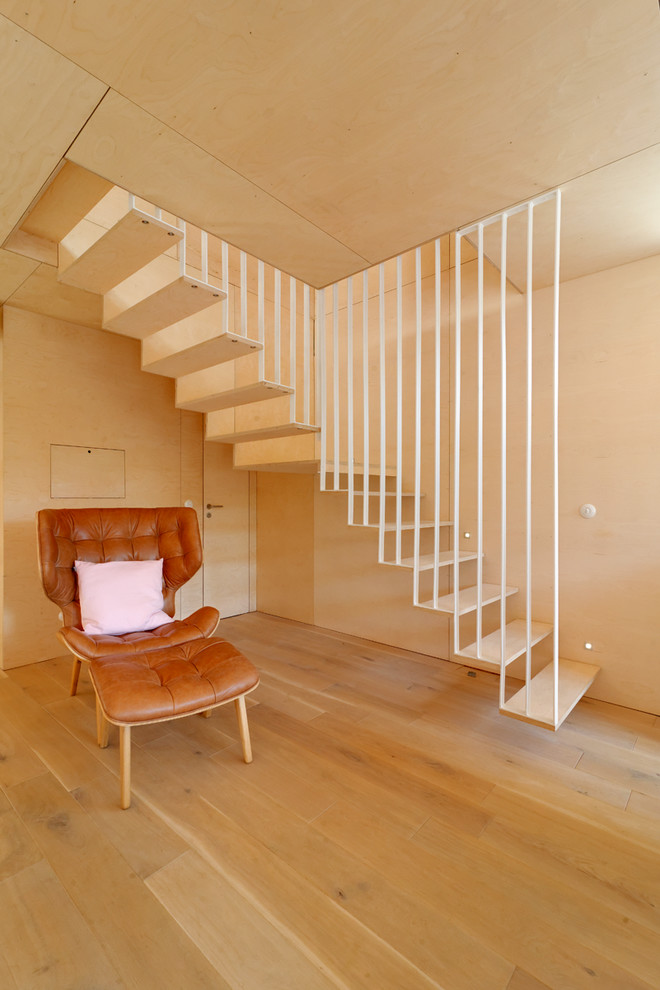 Photo of a large contemporary wood l-shaped staircase in Other with open risers.
