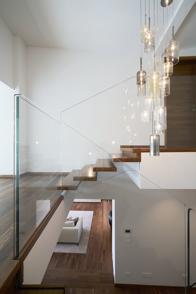 Inspiration for a mid-sized modern painted u-shaped open and glass railing staircase remodel in Munich