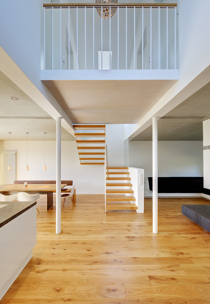 Inspiration for a small contemporary wood u-shaped staircase in Berlin with open risers.