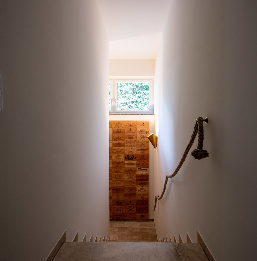 Diseño de escalera recta actual grande con escalones de mármol, contrahuellas de mármol y barandilla de cable