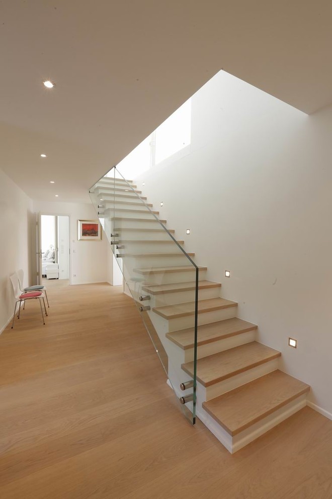 Свежая идея для дизайна: прямая лестница среднего размера в стиле модернизм с деревянными ступенями и крашенными деревянными подступенками - отличное фото интерьера
