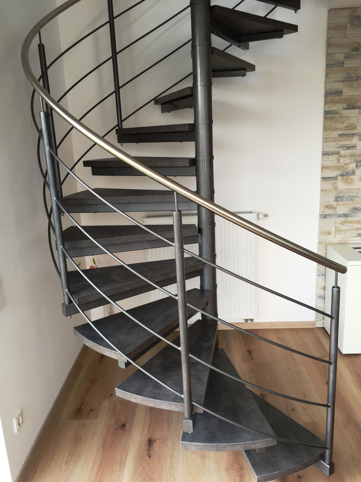 Design ideas for a large contemporary spiral staircase in Other with open risers.