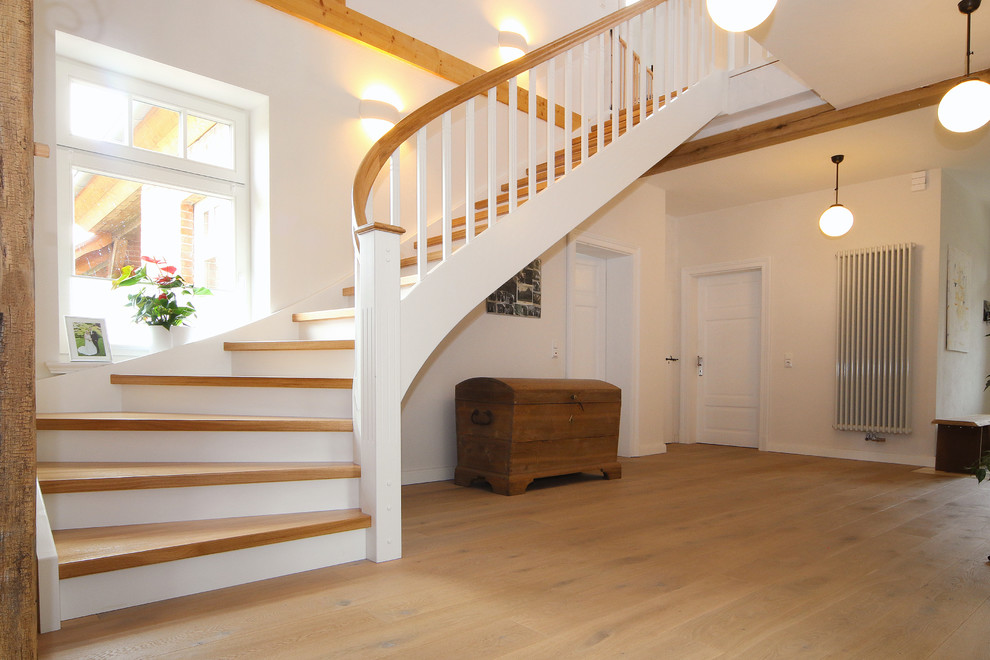 Inspiration for a medium sized farmhouse wood curved wood railing staircase in Other with wood risers.