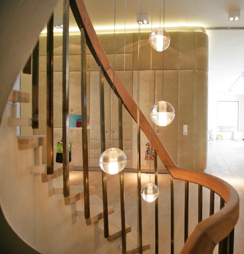 Staircase - large contemporary wooden curved metal railing staircase idea in Other