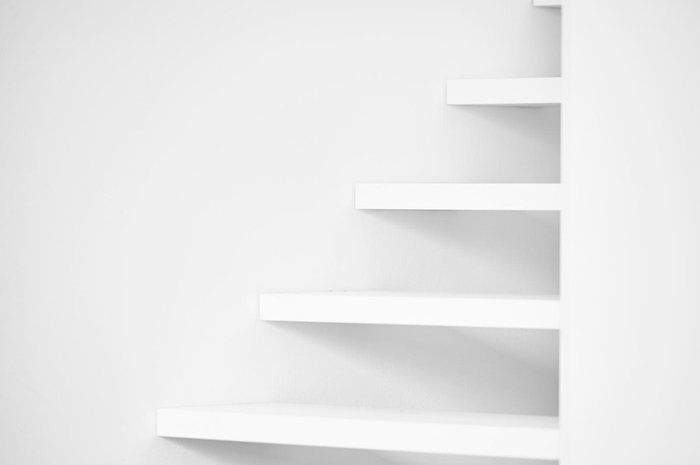 Modelo de escalera curva contemporánea con escalones de madera y contrahuellas de madera