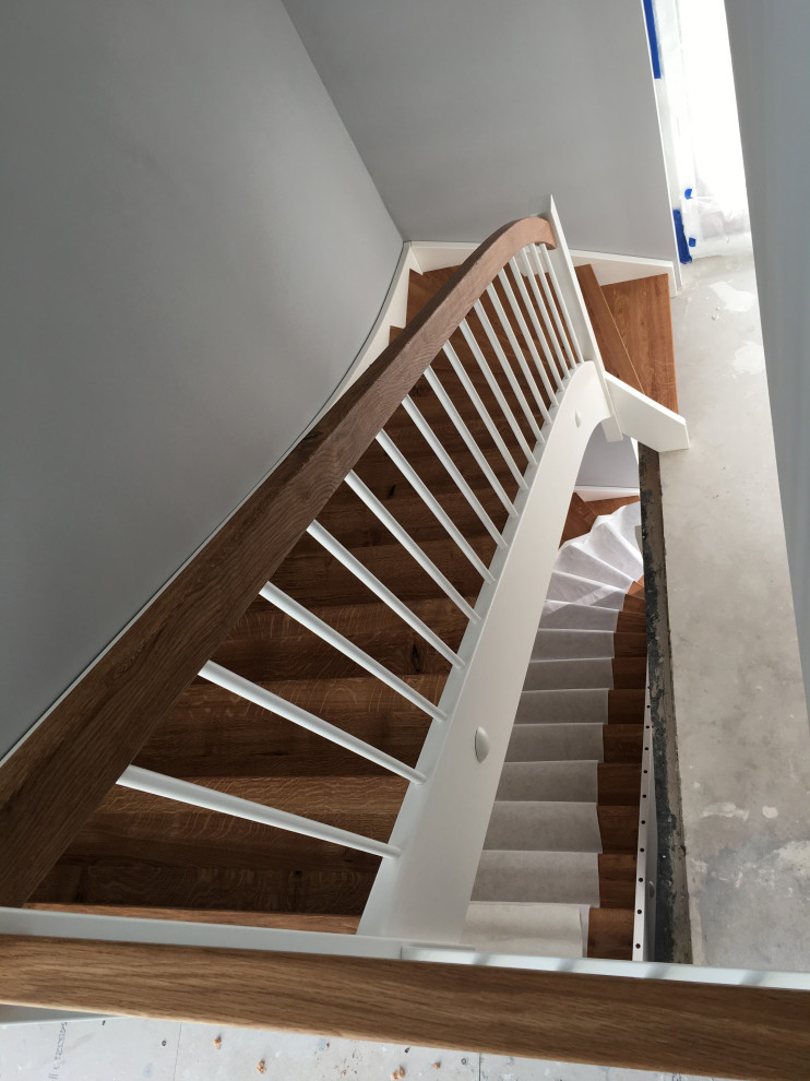 Design ideas for a contemporary wood curved wood railing staircase in Frankfurt.