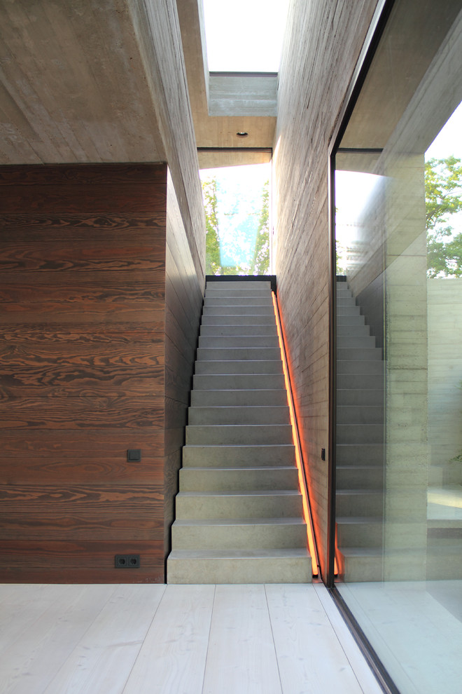This is an example of a large contemporary concrete straight staircase in Hanover with concrete risers.