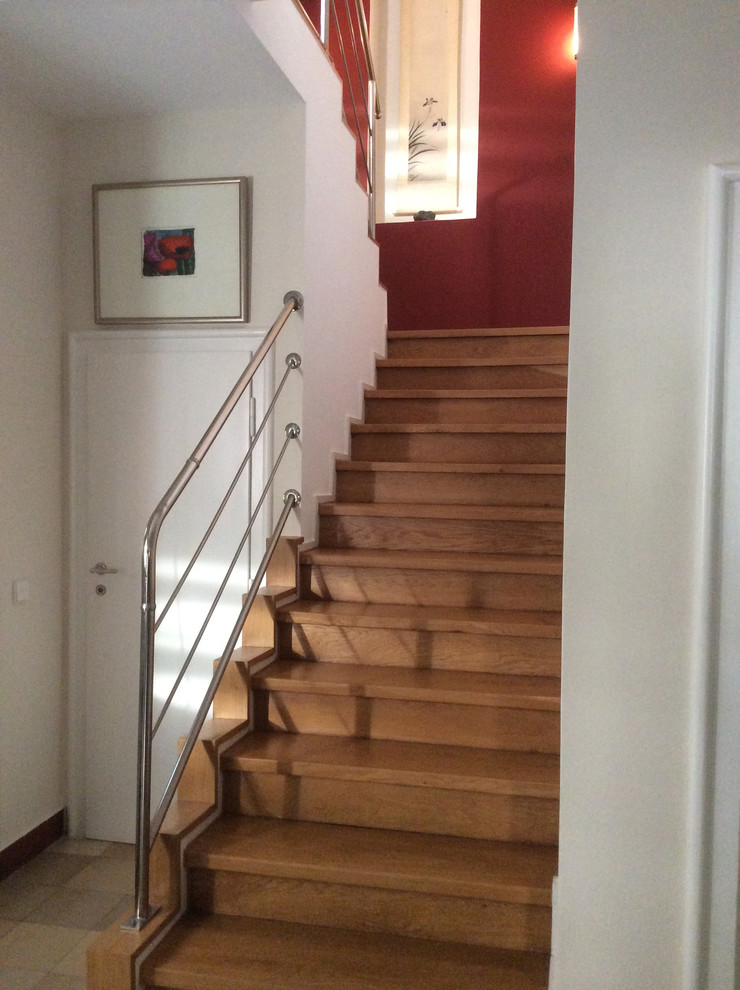 Small trendy l-shaped metal railing staircase photo in Other