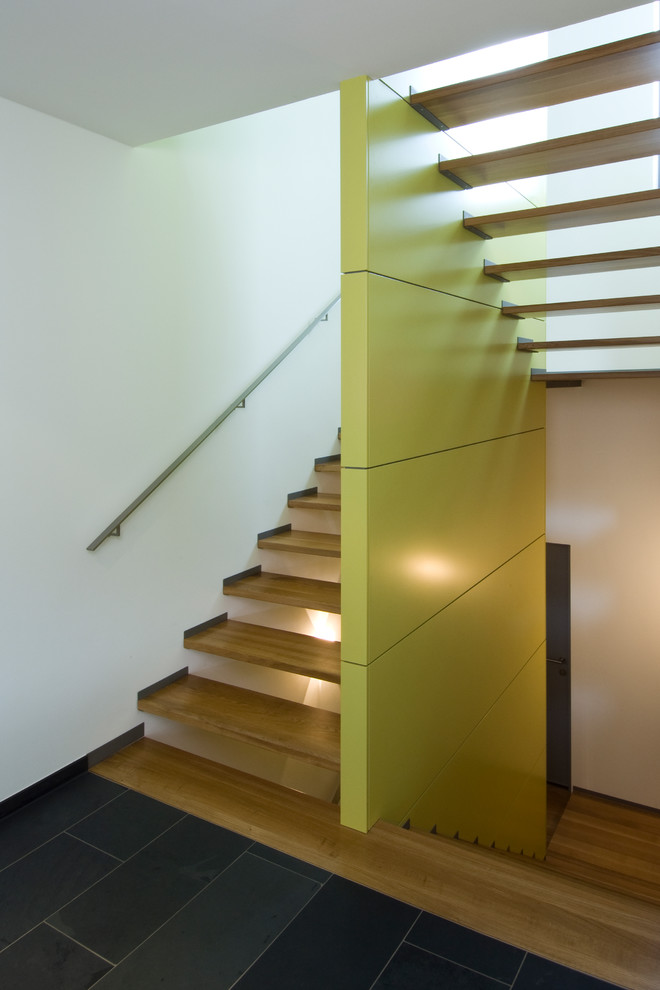 Inspiration for a mid-sized contemporary wooden u-shaped open staircase remodel in Stuttgart