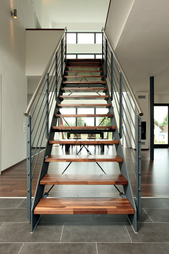 Идея дизайна: прямая лестница в современном стиле с деревянными ступенями и металлическими перилами без подступенок