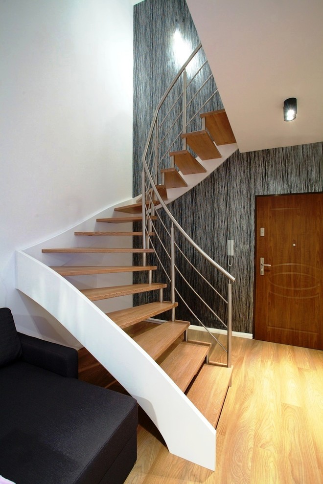 Idées déco pour un grand escalier sans contremarche courbe contemporain avec des marches en bois et éclairage.