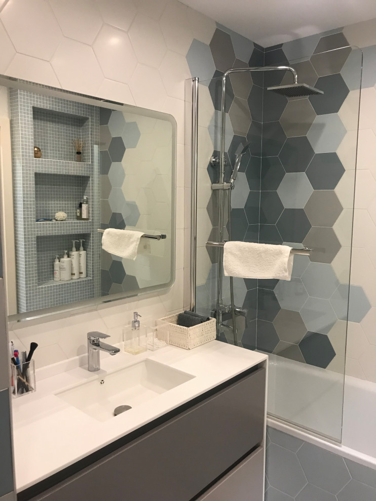 Small contemporary cloakroom in Moscow with flat-panel cabinets, grey cabinets, a one-piece toilet, multi-coloured tiles, ceramic tiles, multi-coloured walls, ceramic flooring, a submerged sink, solid surface worktops, white floors, white worktops and a floating vanity unit.