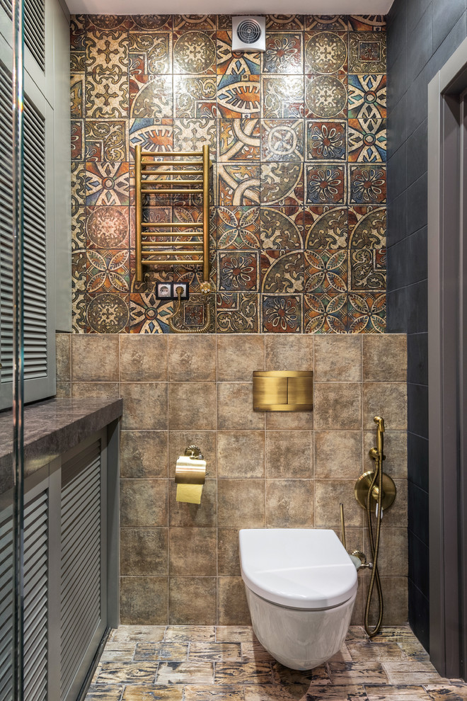 Design ideas for a bohemian cloakroom in Other with a wall mounted toilet, brown tiles and multi-coloured tiles.
