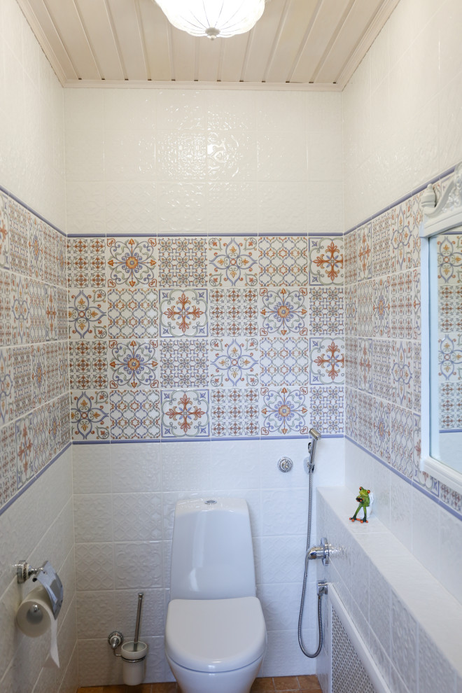 This is an example of a small country cloakroom in Other with a one-piece toilet, white tiles, ceramic tiles, multi-coloured walls, ceramic flooring, brown floors and a timber clad ceiling.