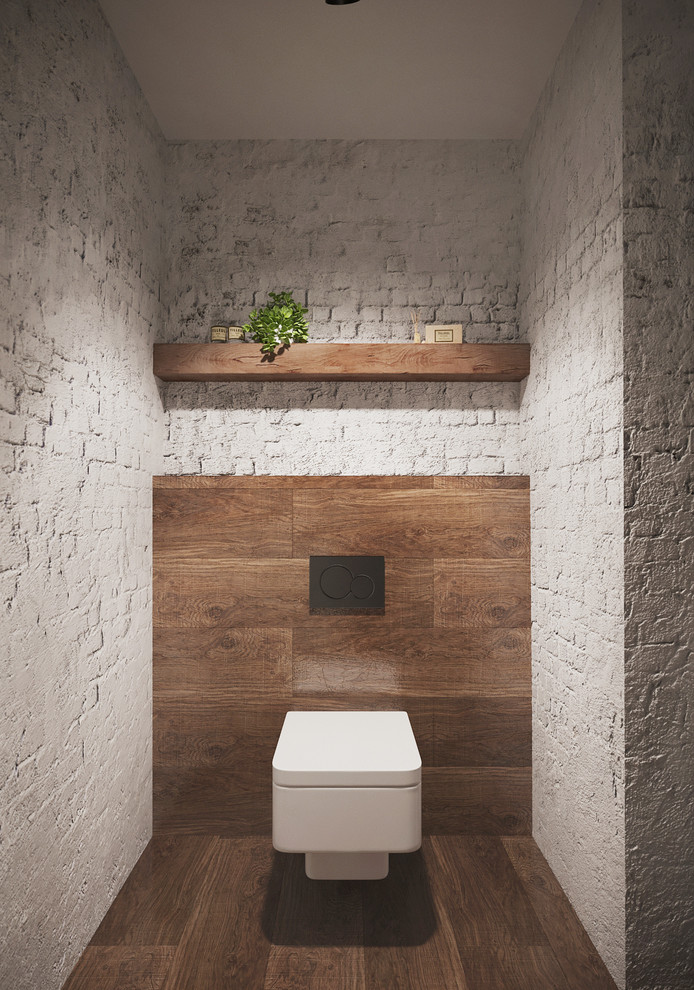 Идея дизайна: маленький туалет в современном стиле с инсталляцией, серой плиткой, белыми стенами, полом из керамической плитки, монолитной раковиной и коричневым полом для на участке и в саду