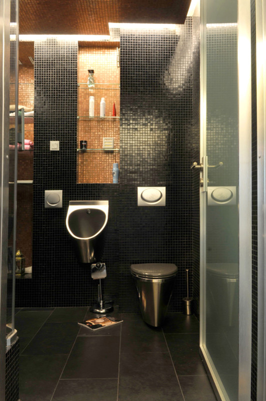 Photo of a medium sized contemporary cloakroom in Moscow with a wall mounted toilet, black tiles, mosaic tiles, black walls and slate flooring.