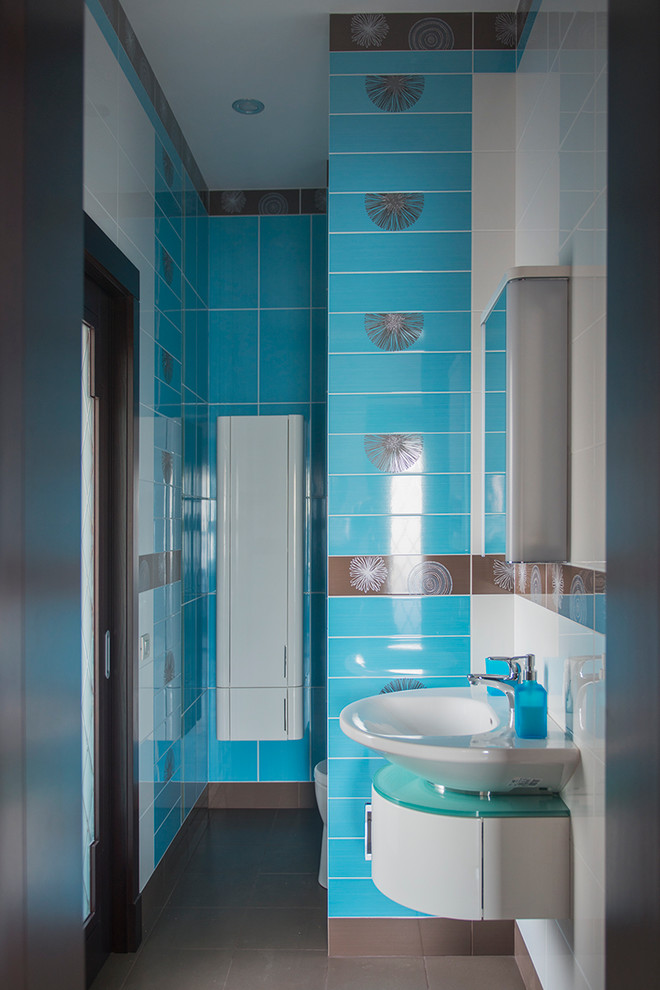 Inspiration for a small contemporary cloakroom in Moscow with flat-panel cabinets, white cabinets, a one-piece toilet, multi-coloured tiles, ceramic tiles, multi-coloured walls, ceramic flooring and a vessel sink.