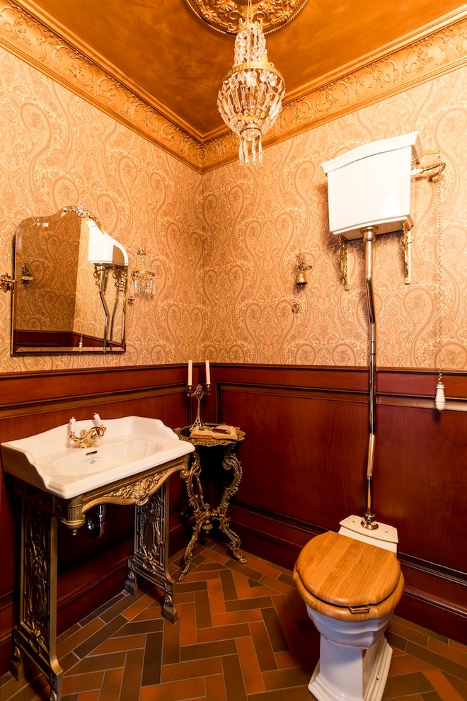 Ispirazione per un bagno di servizio vittoriano con WC a due pezzi, pareti marroni e lavabo integrato