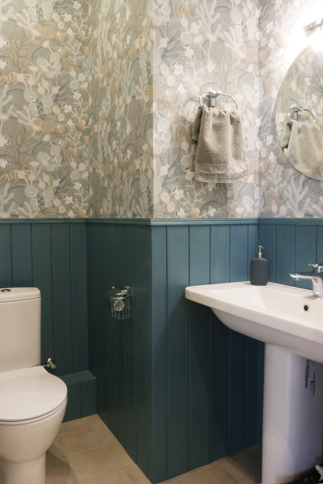 На фото: туалет среднего размера в морском стиле с раздельным унитазом, синими стенами, полом из керамической плитки, раковиной с пьедесталом и бежевым полом