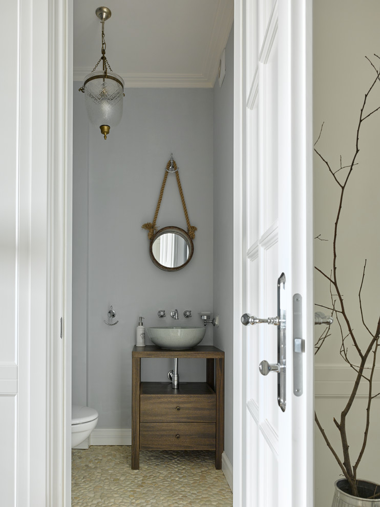 Inspiration for a traditional cloakroom in Moscow with flat-panel cabinets, dark wood cabinets and a vessel sink.